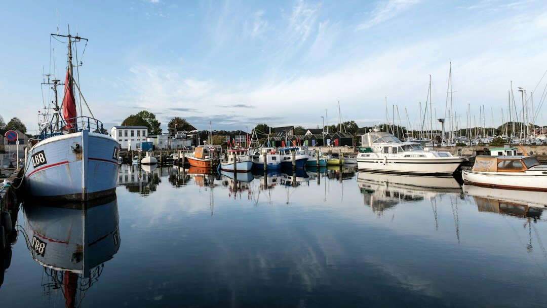 Fishing boats docked in a small Danish harbor at dawn